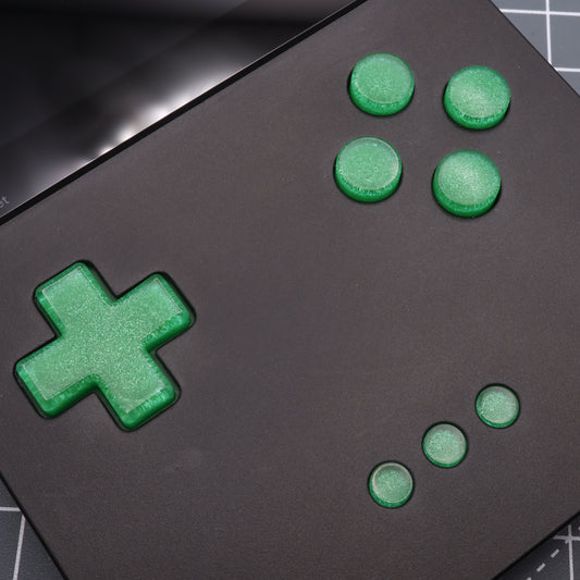 Close-up of Analogue Pocket - Custom Button - Lime Candy on a black retro handheld device with custom-cast buttons and a directional pad against a grid background.