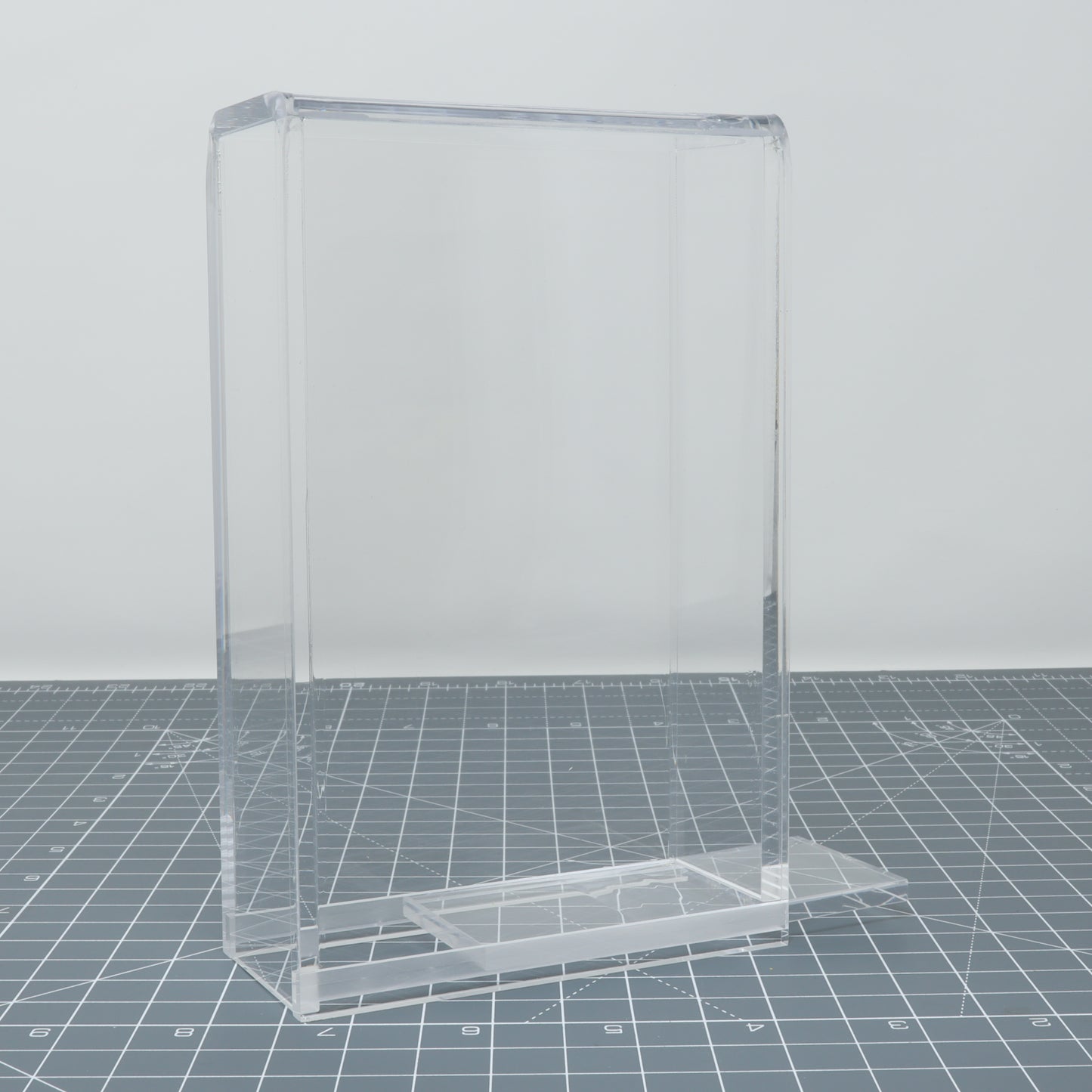 Empty Game Boy DMG Display Capsules brochure holder on a grid background.