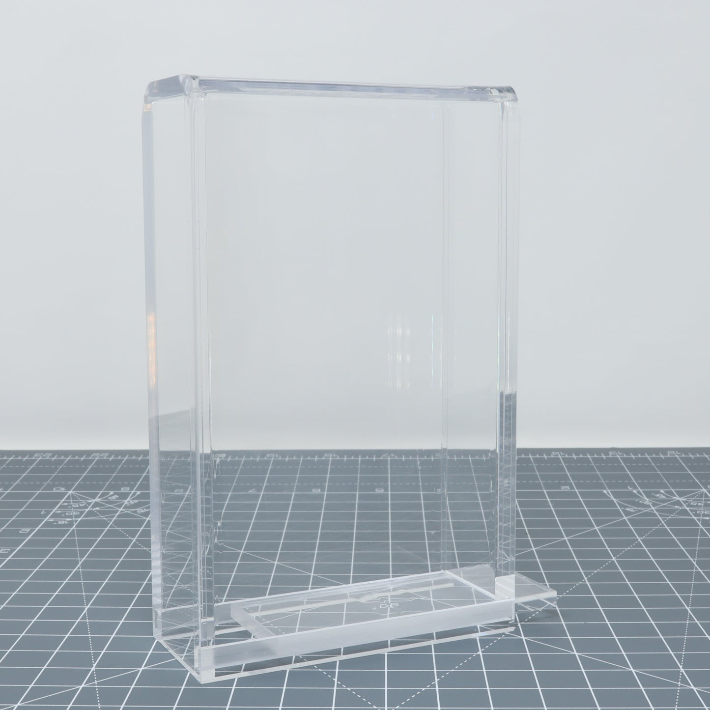 Transparent acrylic Game Boy Light display capsules on a console display case background.