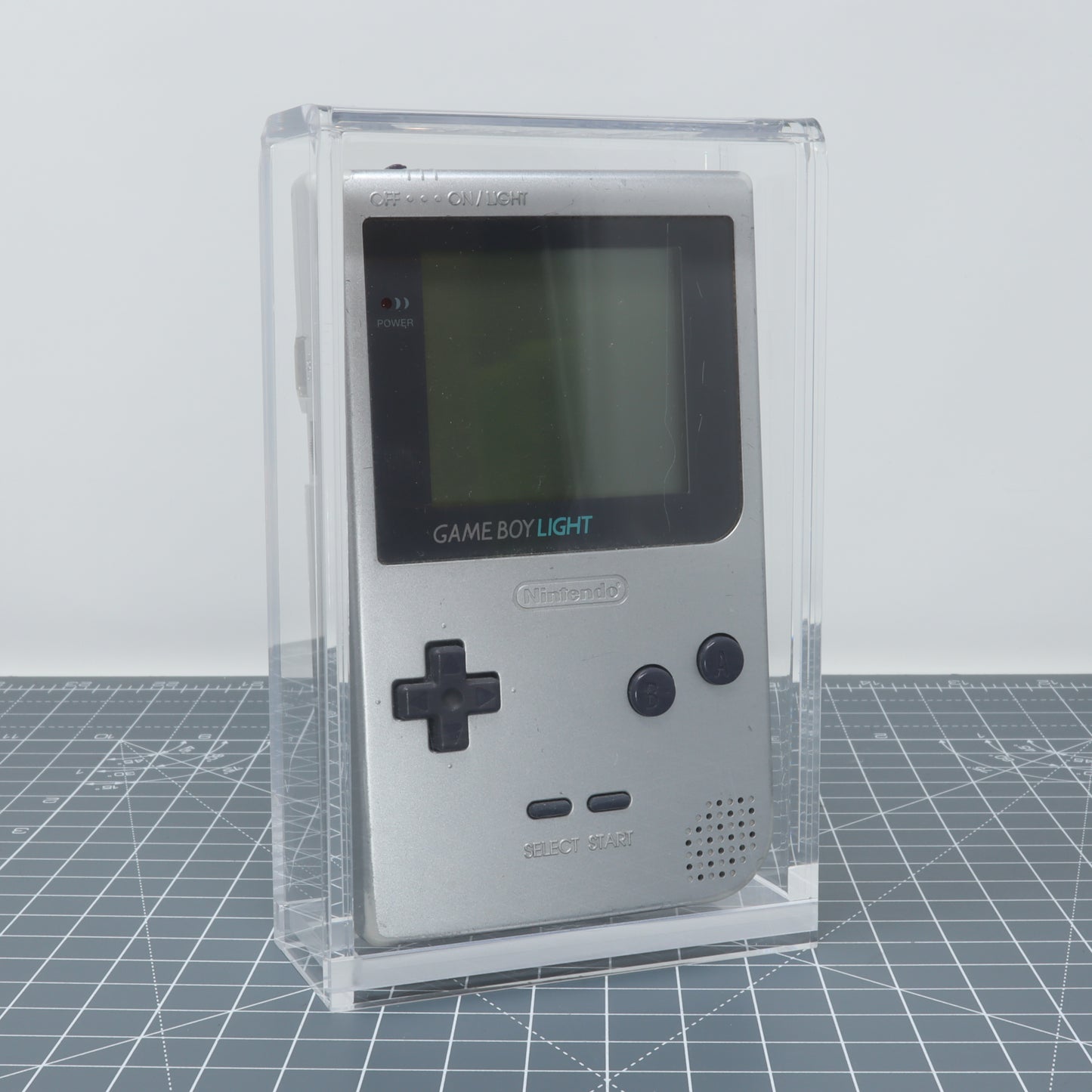 Game Boy Light - Display Capsule in a protective clear acrylic display capsule.