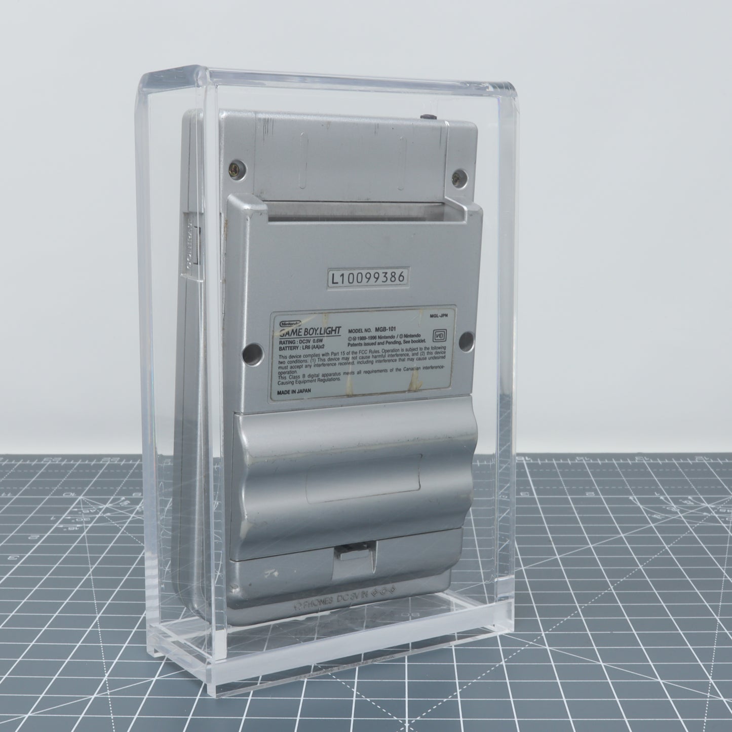 Circuit breaker encased in a Game Boy Light - Display Capsule against a transparent protective box background.