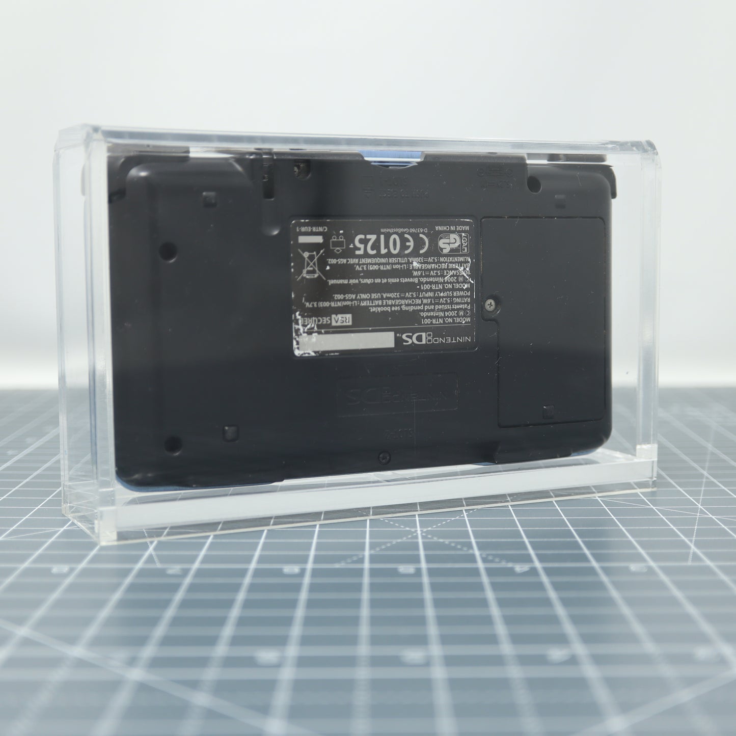 Black nintendo DS original stored in custom acrylic display capsule