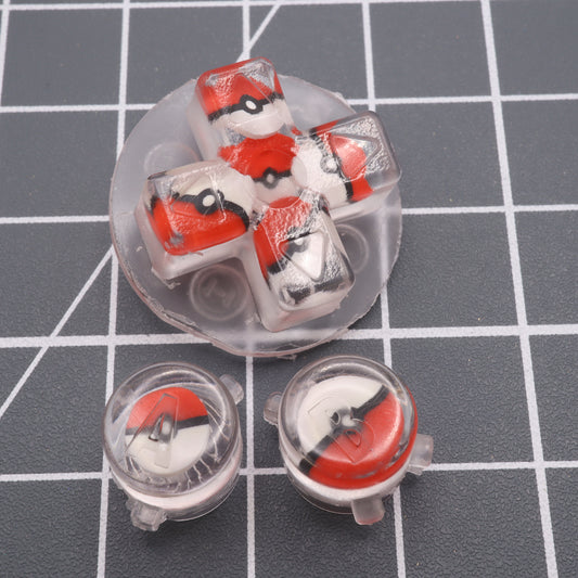 A plastic labfifteen Game Boy Advance and custom-cast Pokeball buttons on a grid surface.