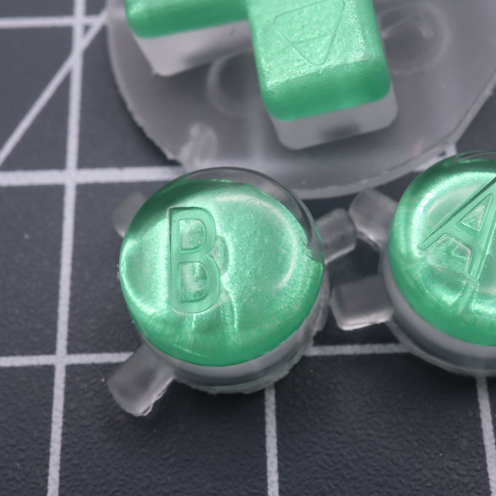 Game Boy Color buttons with lab fifteen co chrome mint green custom buttons close up colour effect