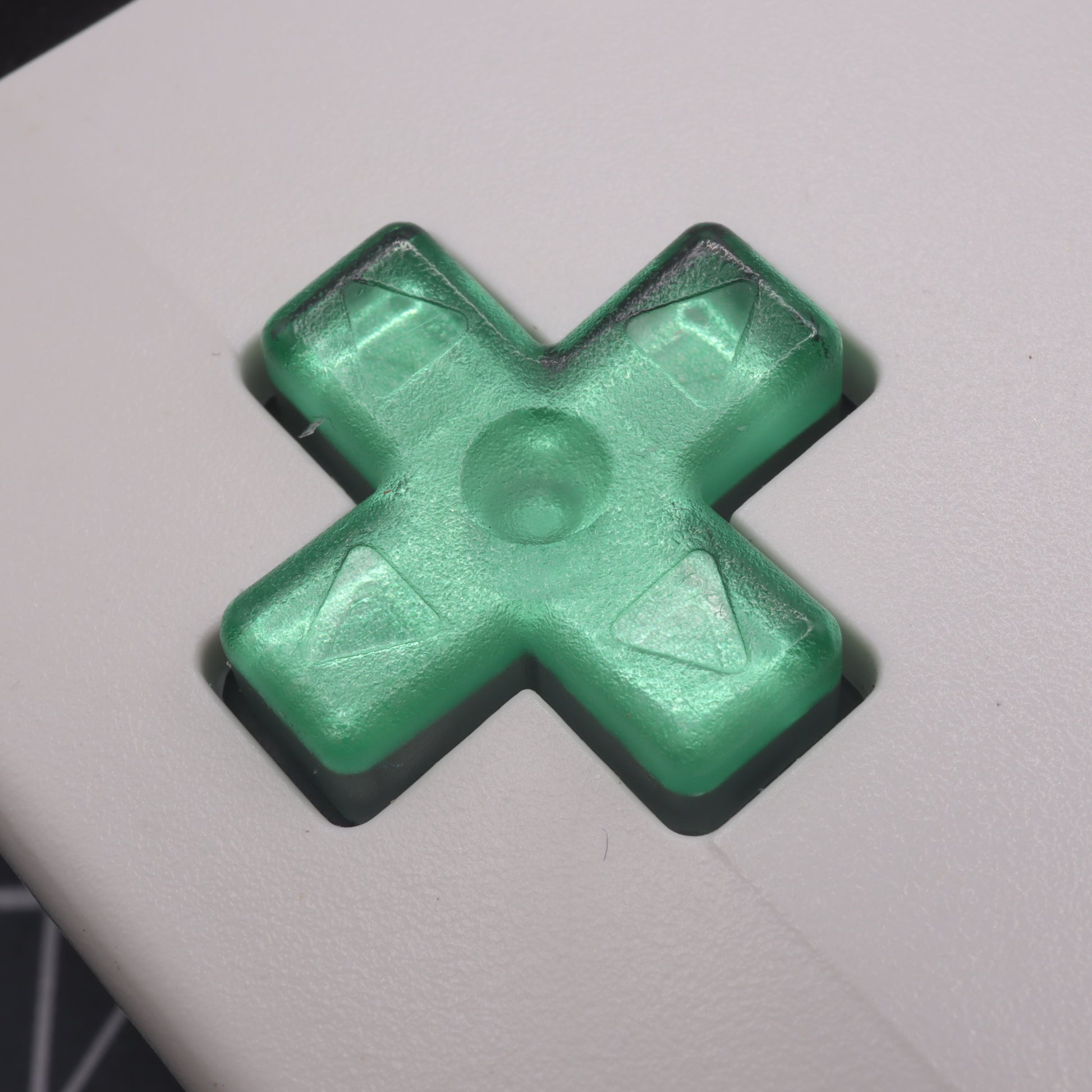 Game Boy Color button with lab fifteen co chrome mint green custom dpad inside white shell close up