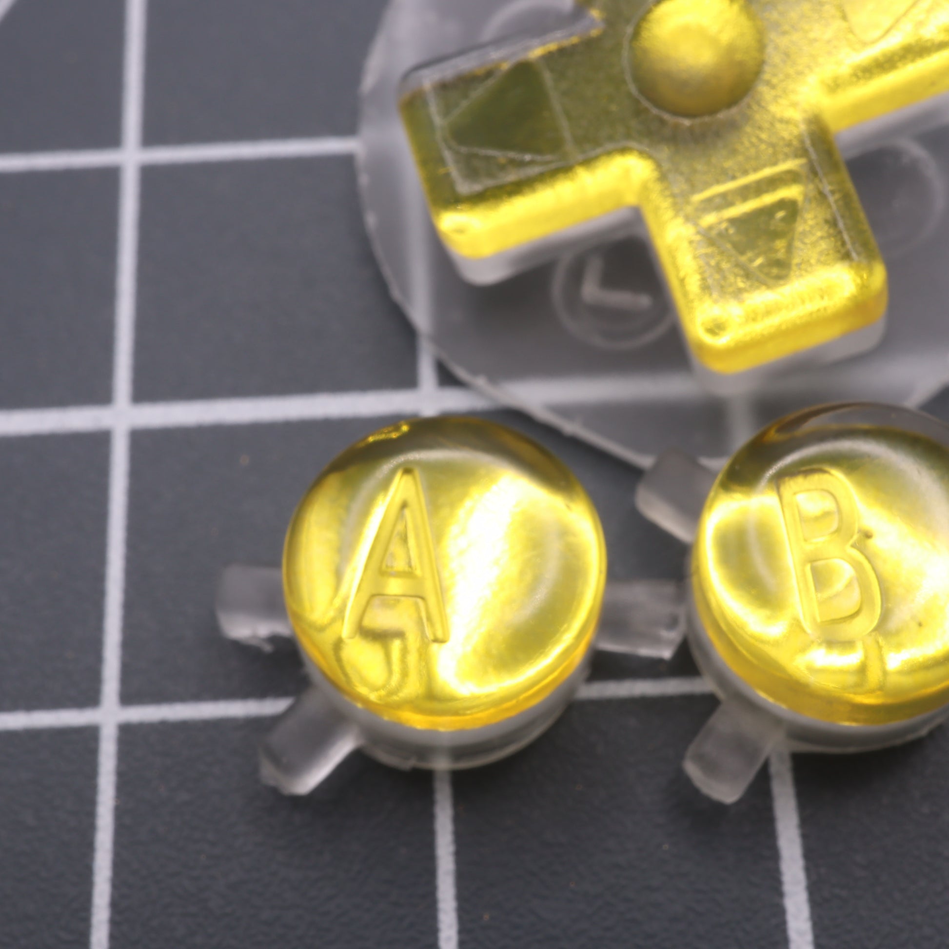 Game Boy Color buttons with lab fifteen co silver chrome gold yellow custom buttons close up effect shimmer