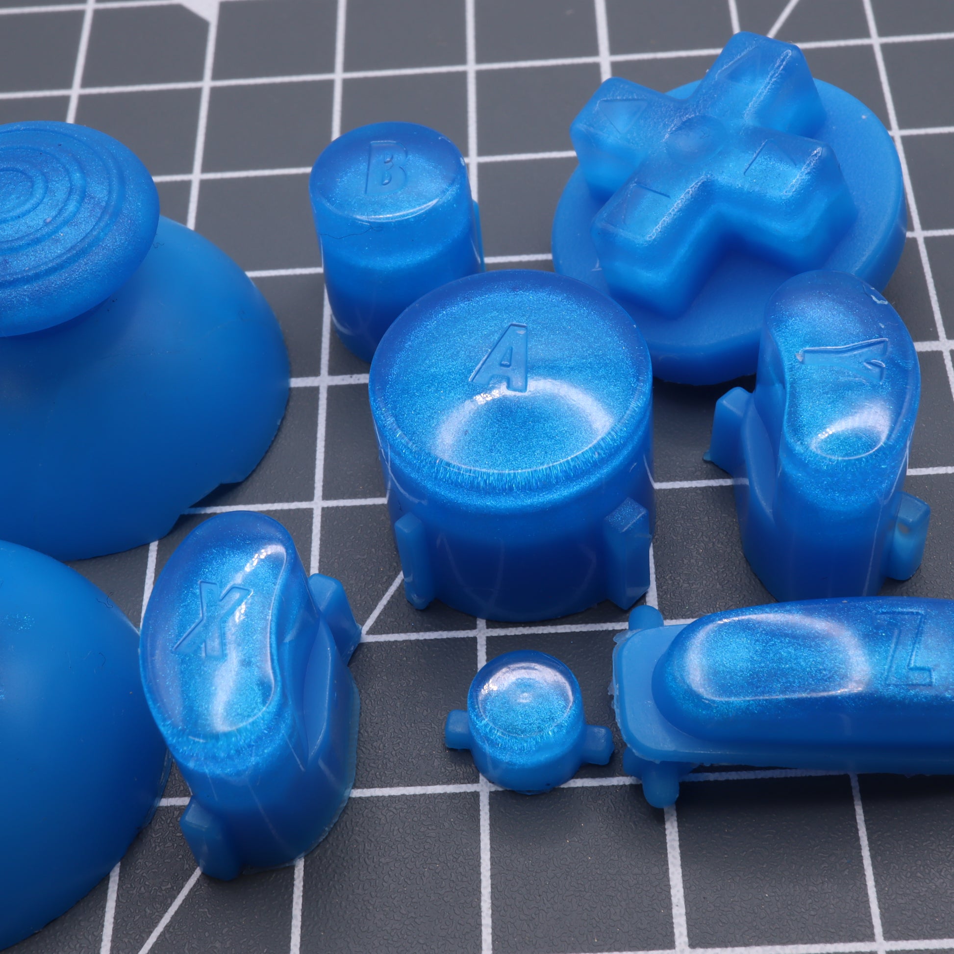 Blue GameCube - Custom Button - Blueberry Candy with various shapes on a grid surface.