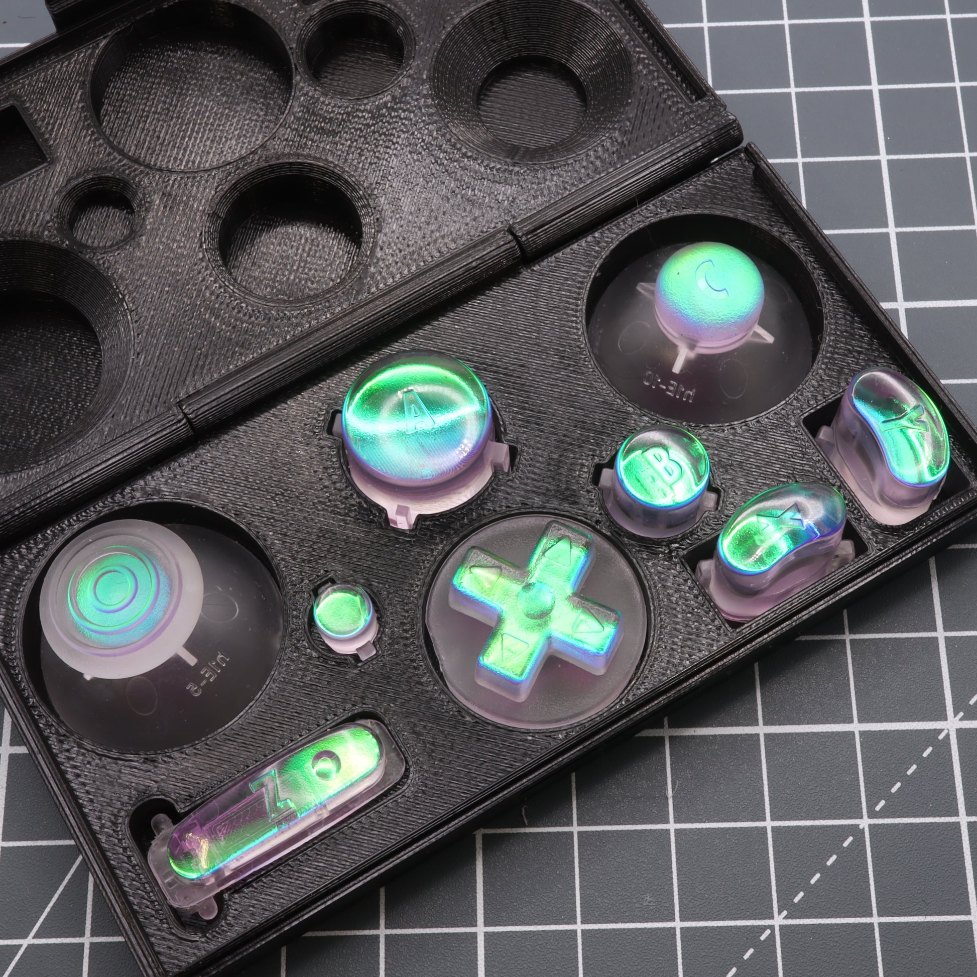 Custom translucent Cool Opal and purple gaming controller buttons with a Dichroic effect displayed in a black case.