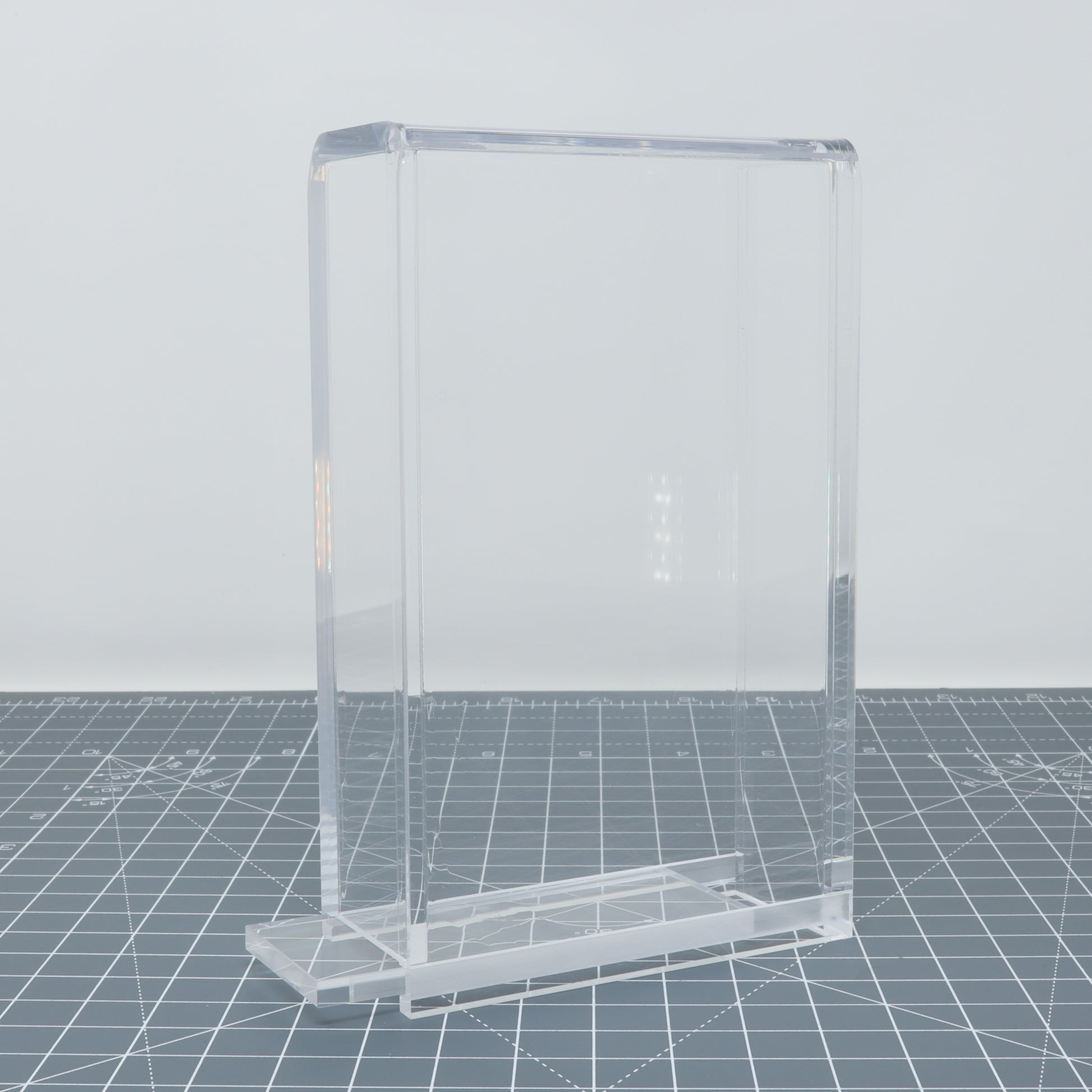 Transparent acrylic display case for Game Boy Color - Display Capsule accessories on a surface.