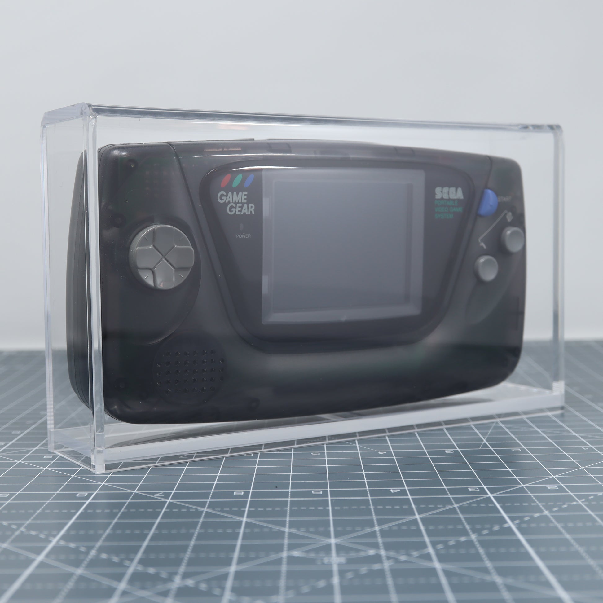 Sega Game Gear Smoke Black edition console on display in custom acrylic display capsule front