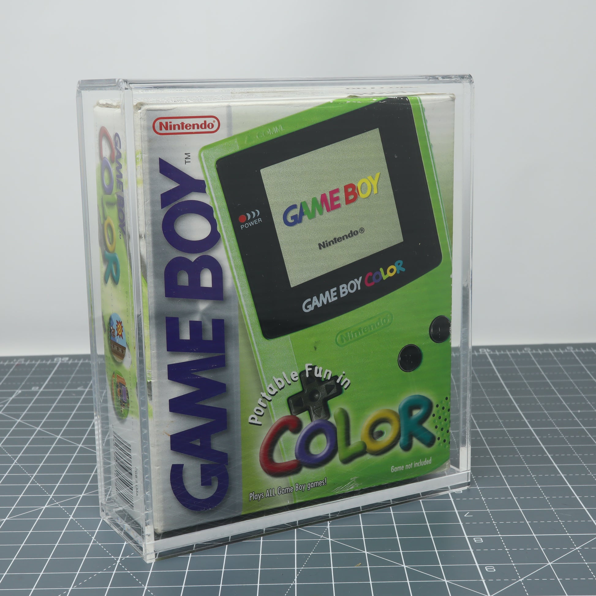 Game Boy Color Kiwi Green boxed console stored inside custom acrylic display capsule front image