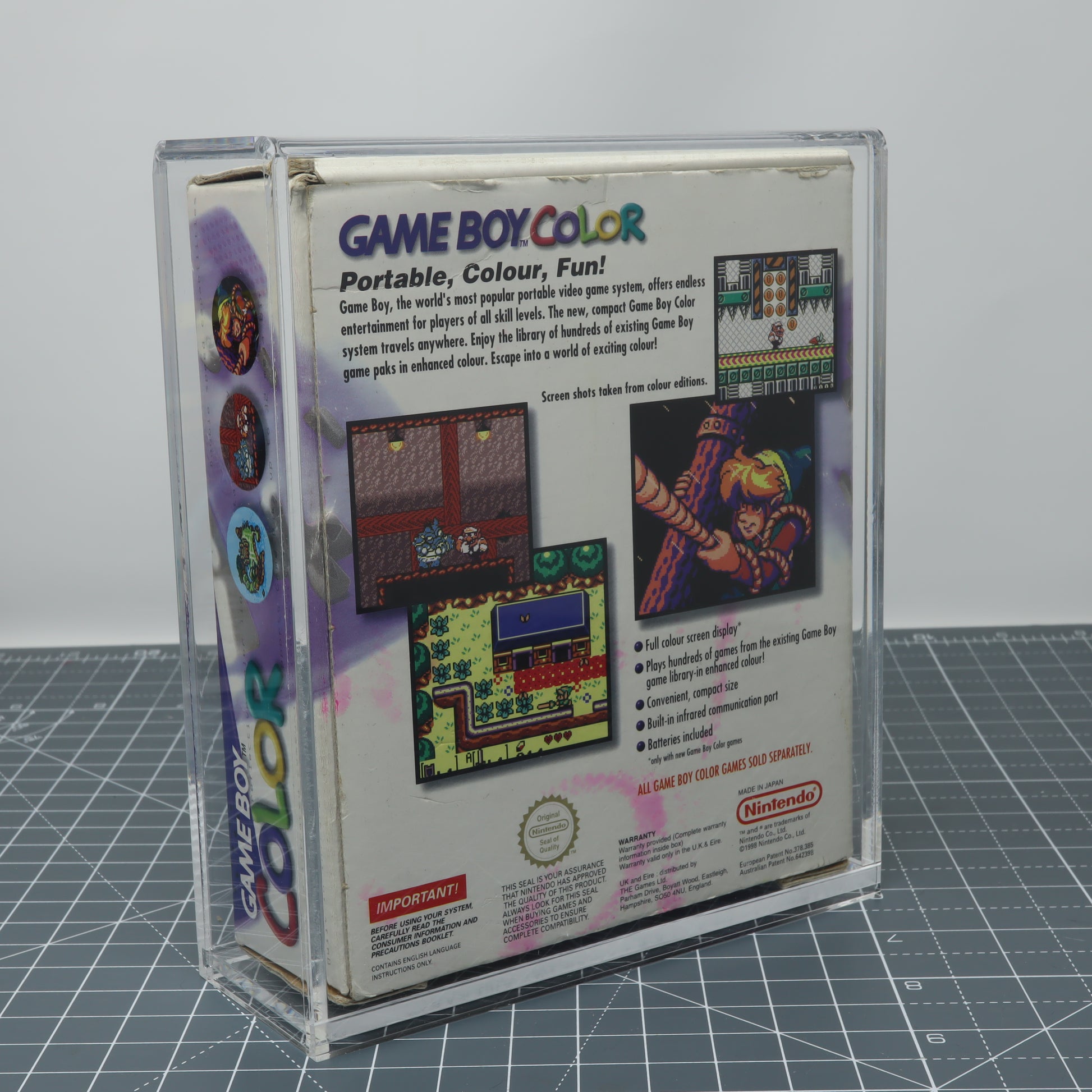 Game Boy Color Grape purple boxed console stored inside custom acrylic display capsule rear image